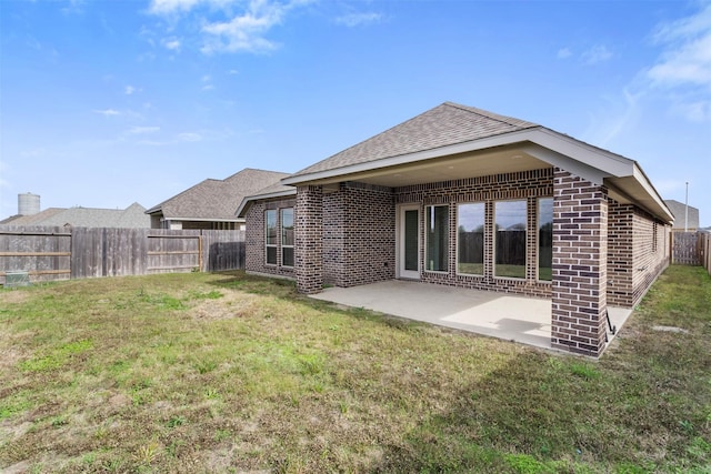 rear view of house with a lawn and a patio area