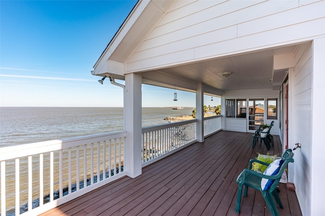 deck with a view of the beach and a water view