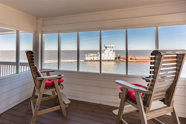 sunroom / solarium with plenty of natural light and a water view