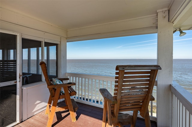 exterior space featuring a water view and a view of the beach