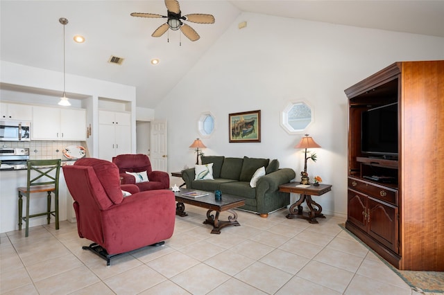 living room featuring light tile patterned floors, high vaulted ceiling, and ceiling fan