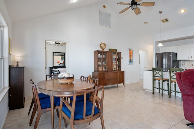 tiled dining space with high vaulted ceiling