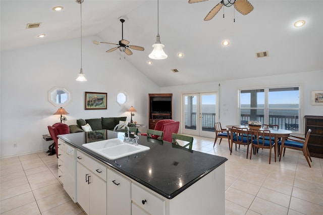 kitchen featuring ceiling fan, sink, a center island with sink, dishwasher, and white cabinetry