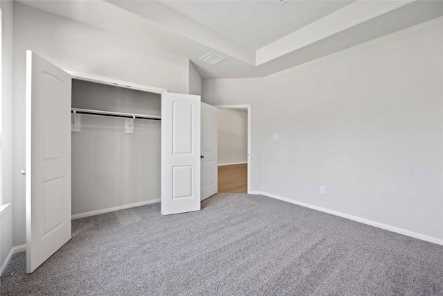 unfurnished bedroom featuring carpet floors and a closet