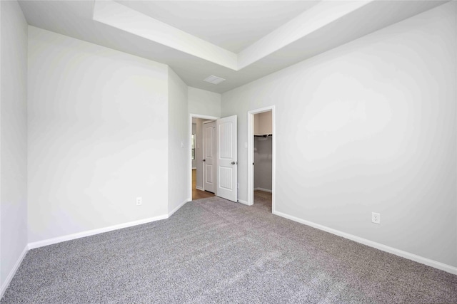 1485 Rd 66114, Dayton, TX 77535 - unfurnished bedroom with carpet floors, baseboards, a raised ceiling, and a spacious closet