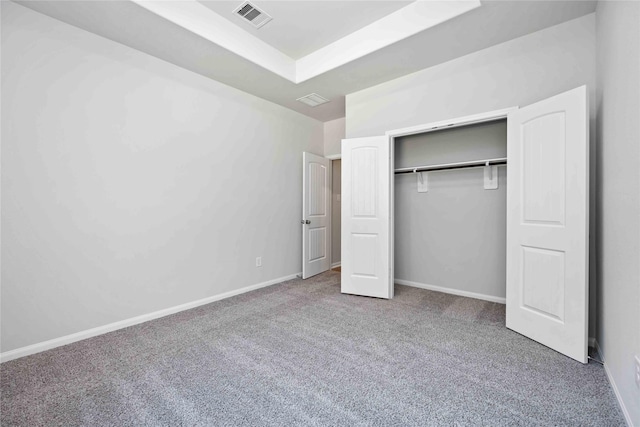 unfurnished bedroom featuring carpet floors and a closet