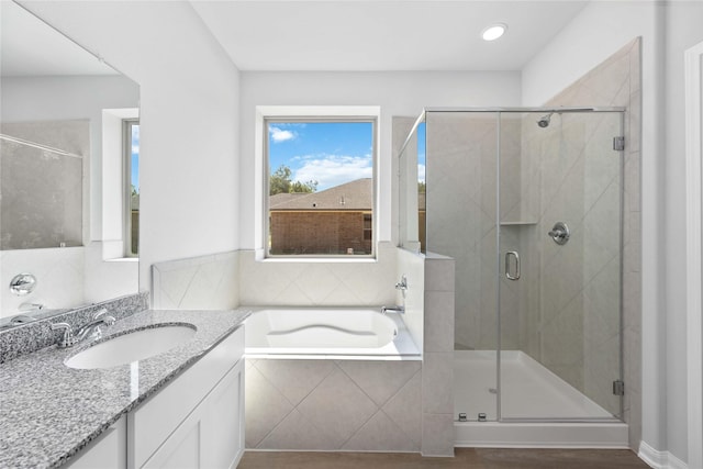 bathroom with separate shower and tub, hardwood / wood-style floors, and vanity