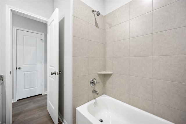 bathroom with tiled shower / bath combo and hardwood / wood-style flooring