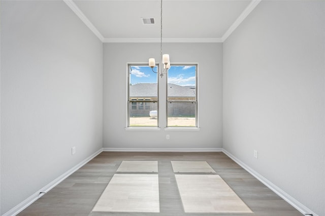 1485 Rd 66114, Dayton, TX 77535 - empty room featuring a chandelier, light wood-type flooring, crown molding, and baseboards