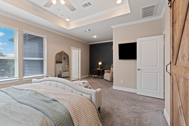 bedroom featuring light carpet, a barn door, ceiling fan, and crown molding