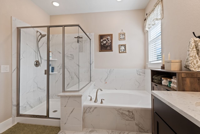 bathroom featuring vanity and separate shower and tub