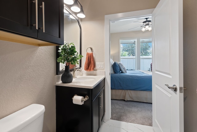 bathroom with ceiling fan, toilet, and vanity