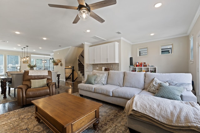 living room with dark hardwood / wood-style flooring, ceiling fan, crown molding, and sink