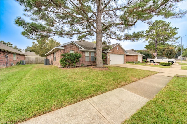 ranch-style house featuring a garage, central air condition unit, and a front lawn