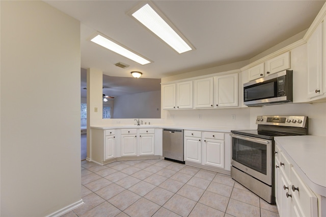 kitchen featuring sink, ceiling fan, light tile patterned floors, white cabinetry, and stainless steel appliances