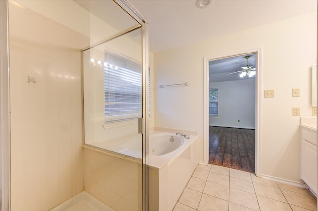 bathroom with tile patterned flooring, vanity, ceiling fan, and plus walk in shower