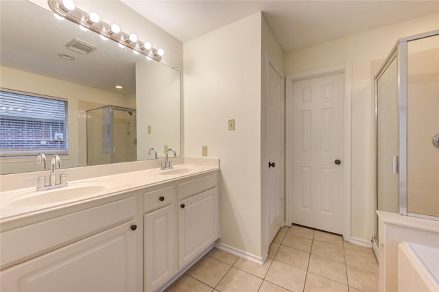 bathroom with vanity, tile patterned floors, and walk in shower