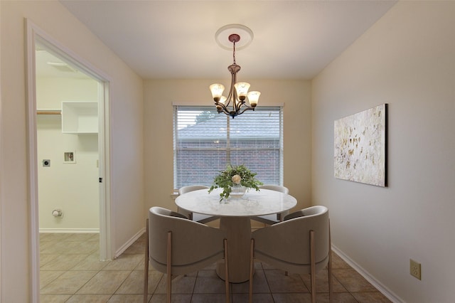 tiled dining area featuring an inviting chandelier