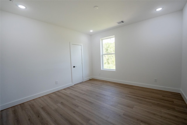 unfurnished room featuring hardwood / wood-style floors