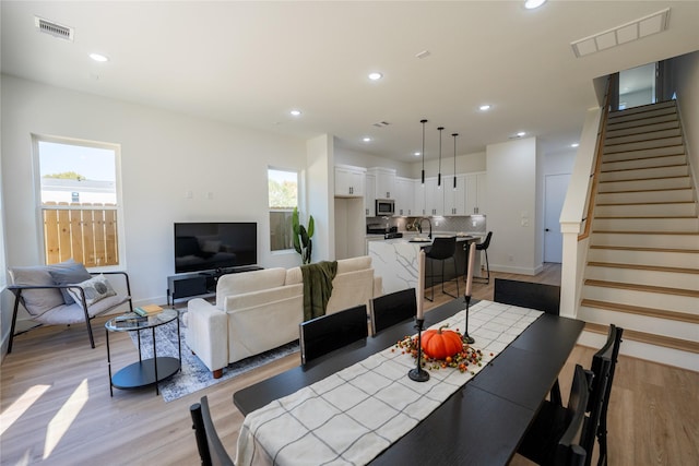 dining room featuring plenty of natural light, light hardwood / wood-style floors, and sink