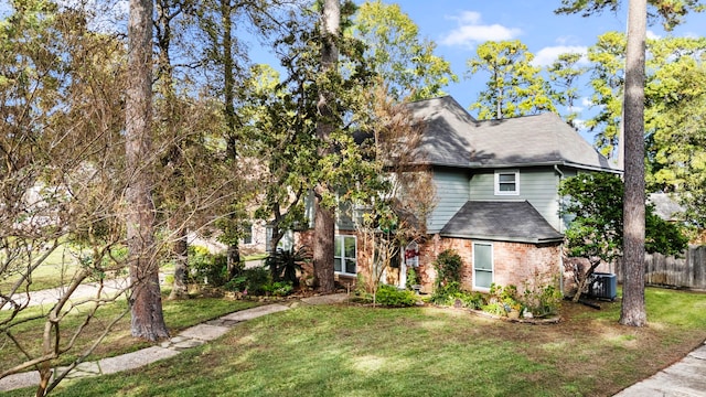 view of front of property featuring central air condition unit and a front yard