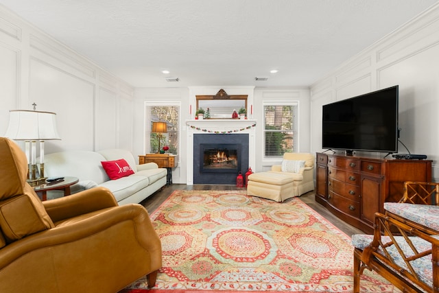 living room featuring a textured ceiling and light hardwood / wood-style floors