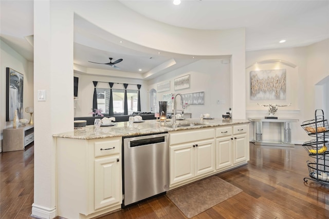 kitchen featuring dark wood-type flooring, sink, stainless steel dishwasher, ceiling fan, and light stone counters