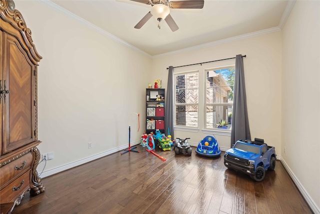 recreation room with dark hardwood / wood-style floors, ceiling fan, and crown molding