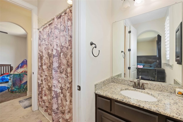 bathroom with curtained shower and vanity