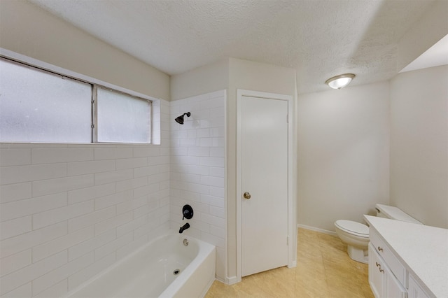 full bathroom featuring vanity, toilet, a textured ceiling, and tiled shower / bath combo