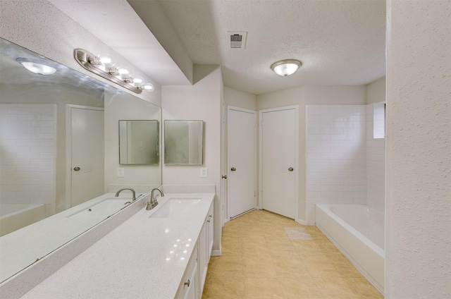 bathroom featuring vanity and a textured ceiling