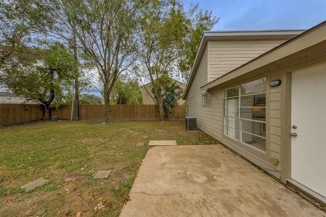 view of yard with cooling unit and a patio