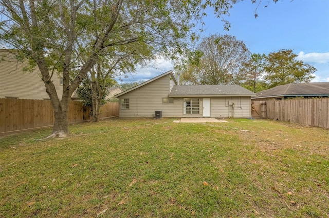 back of property with cooling unit, a patio area, and a lawn