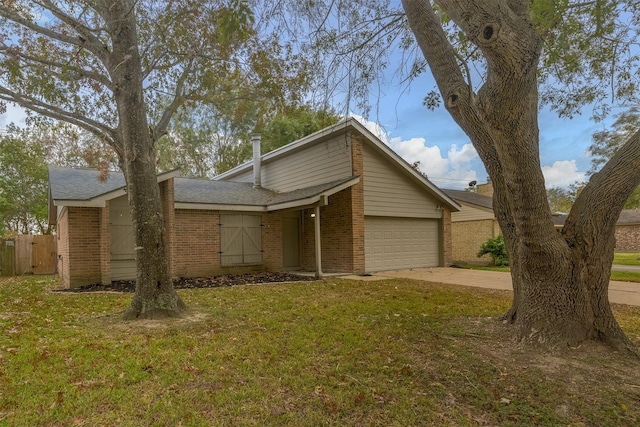 view of front of house with a front yard and a garage