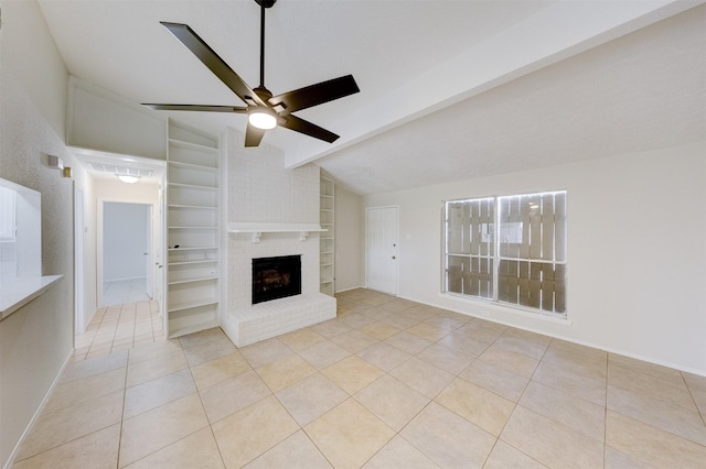 unfurnished living room featuring a brick fireplace, vaulted ceiling with beams, ceiling fan, built in features, and light tile patterned floors