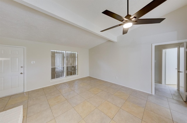 empty room with vaulted ceiling with beams, ceiling fan, and light tile patterned flooring