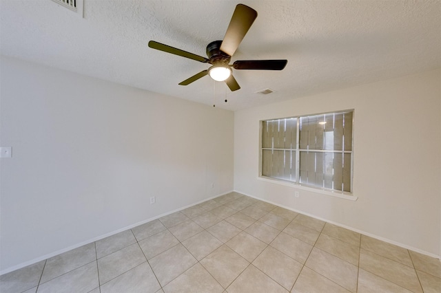 unfurnished room with light tile patterned floors, a textured ceiling, and ceiling fan