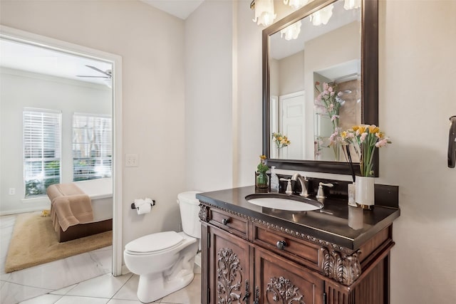 bathroom featuring toilet, vanity, tile patterned floors, and ceiling fan