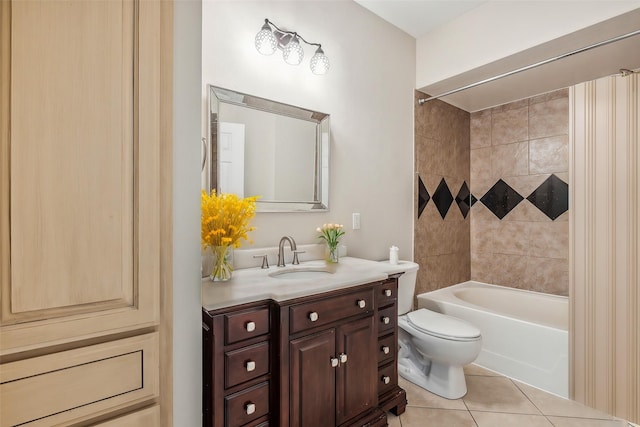 full bathroom with tile patterned floors, toilet, vanity, and tiled shower / bath