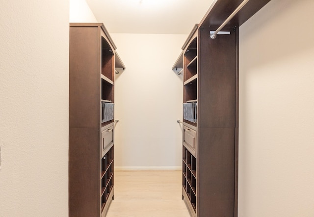 spacious closet featuring light wood-type flooring