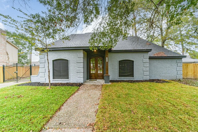 view of front facade with french doors and a front lawn