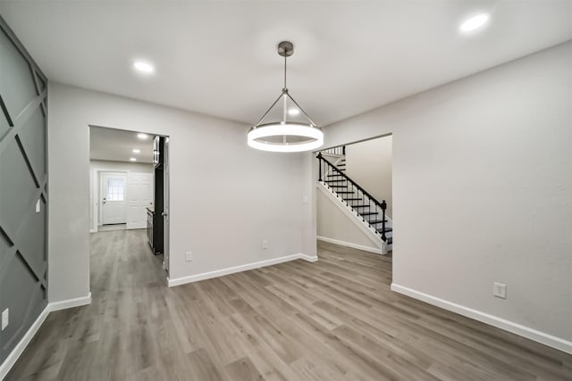 unfurnished dining area featuring hardwood / wood-style floors