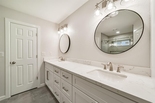 bathroom featuring vanity and a shower with door