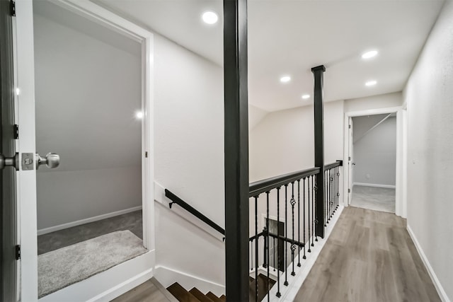 interior space with hardwood / wood-style floors and vaulted ceiling