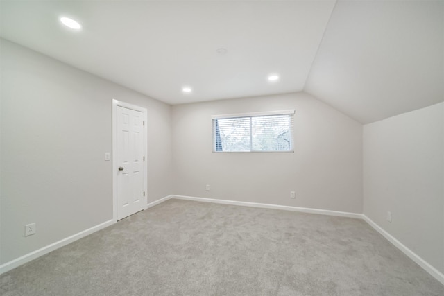 bonus room with light carpet and lofted ceiling