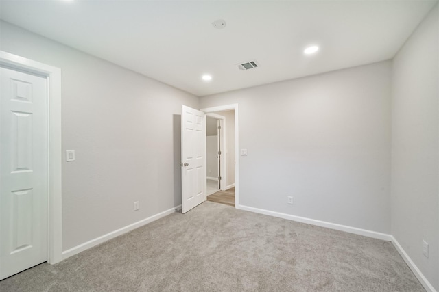 spare room with light colored carpet