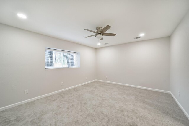 carpeted empty room featuring ceiling fan