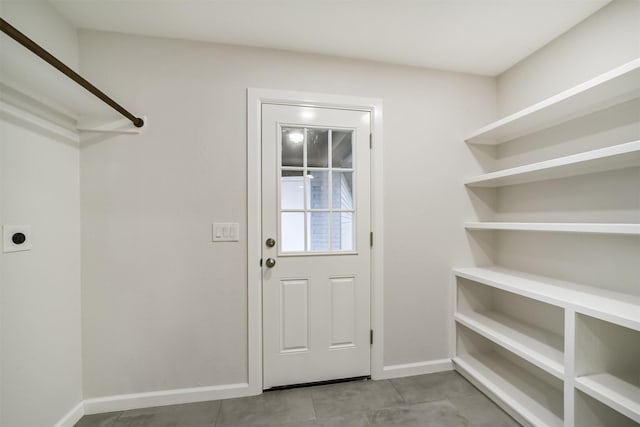 doorway to outside featuring light tile patterned flooring