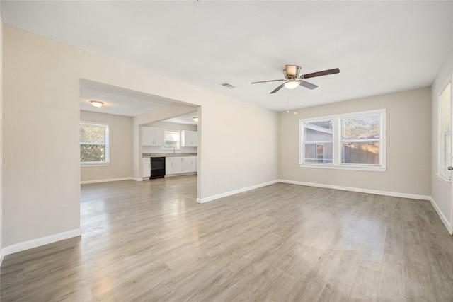 spare room with ceiling fan and light hardwood / wood-style flooring