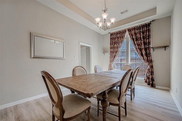 dining room featuring a chandelier and light hardwood / wood-style floors